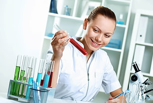 woman checking blood on test tube HD wallpaper